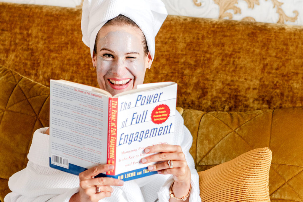 Business Woman reading a business book in portsmouth hotel room, facemask, bathrobe, hair towel, Hampshire personal brand shoot